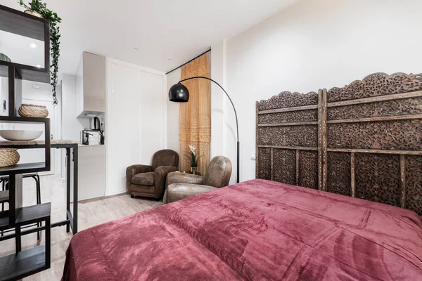 Small vacation rental apartment with sofa with red velvet blanket and Arabic decoration and camel leather sofas