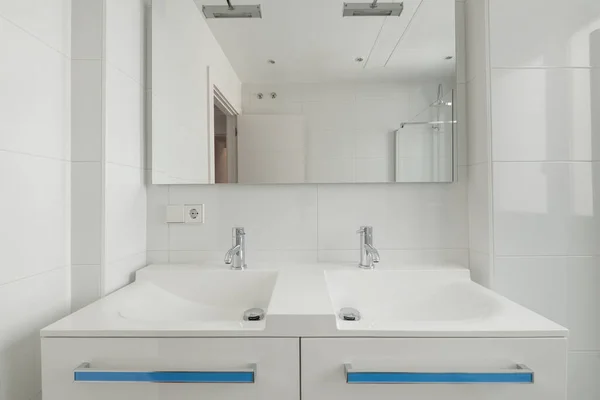 New cloakroom with double white porcelain sink and rectangular frameless mirror