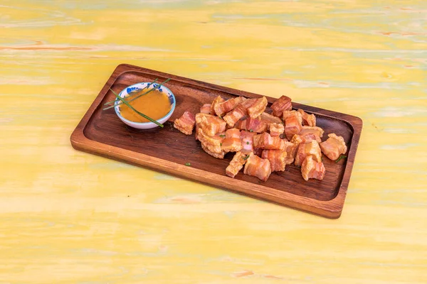 Tipik İspanyol usulü torreznos de soria, zeytin yağında kızartılmış, ahşap bir tepside, ahşap bir tepside sos.