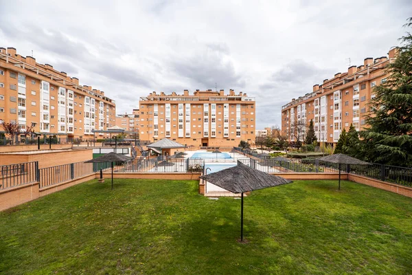 Common areas with swimming pools and gardens in an urbanization of urban residential buildings