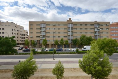 Facades of modern urban residential buildings seen from the street with a cloudy and clear sky