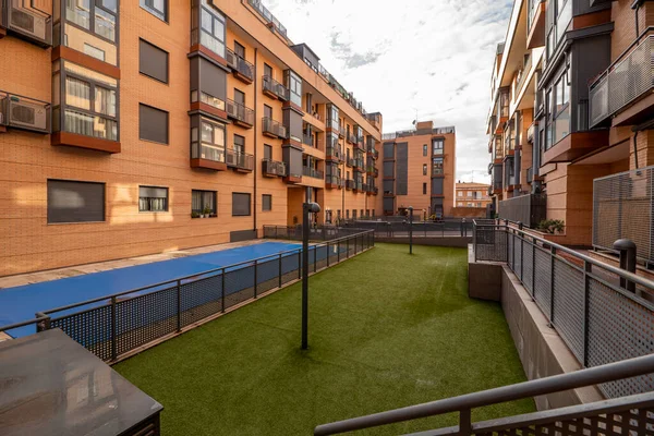 Indoor common areas with artificial grass floors and indoor pool in an urban residential housing development