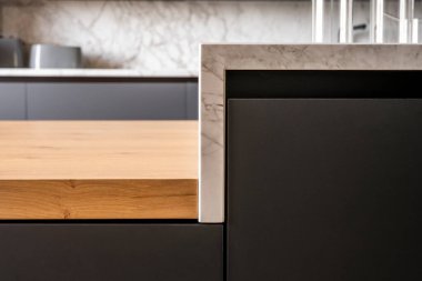 details of the materials of a luxury kitchen with wood, glass and veined marble