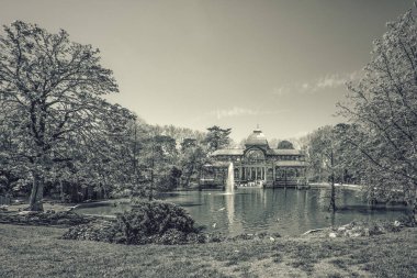Black and white landscape of Parque del Retiro lake with Crystal Palace and trees