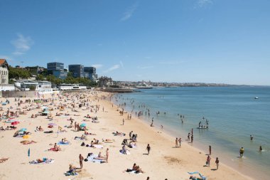 Estoril beach full of bathers on a clear summer day