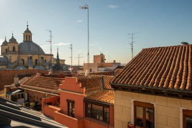 Clay tile roofs and dome of the church of san Miguel in the old town of Madrid