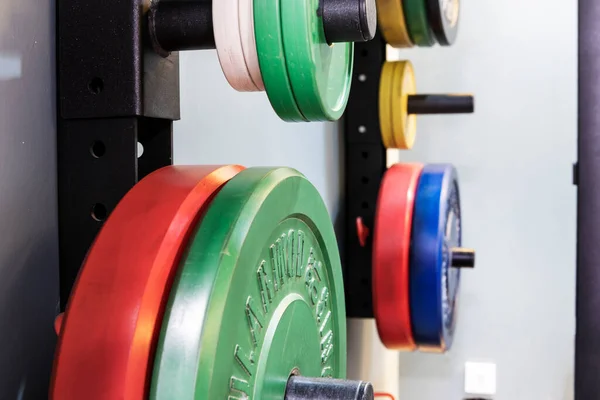 Colored metal weights of different color hanging in place