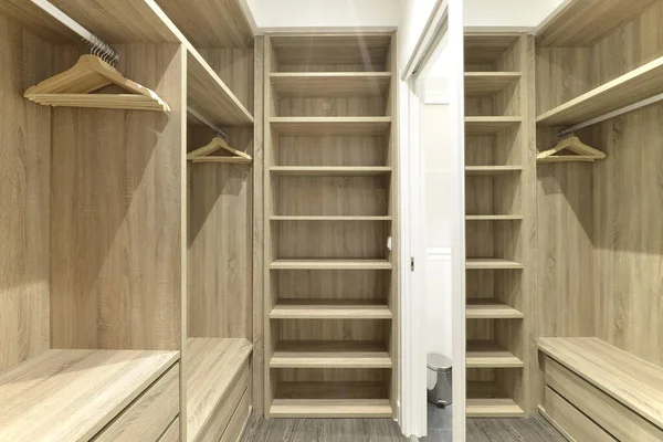 Walk-in closet with mirror, wooden shelves, chest of drawers, closet rods and many wooden hangers