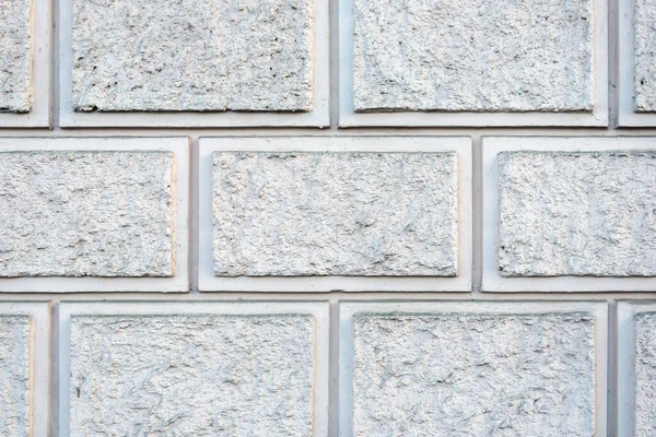 Gri kaba taştan yapılmış bir duvarın taklidi. Blokların mazonisi. Dekoratif alçı. Arkaplan veya doku için