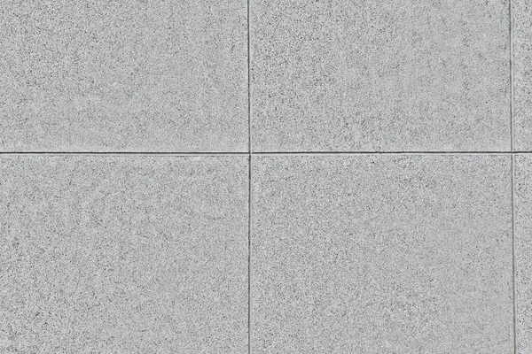 Binanın duvarında büyük gri mermer fayanslar var. Parça. Arkaplan veya doku