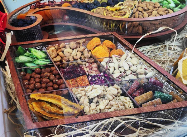 Different Oriental, Turkish nuts and sweets in a wooden box on the shop window — Stock Photo, Image