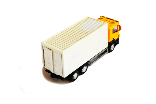 A yellow semi truck with a white trailer attached. Isolated on a white background.