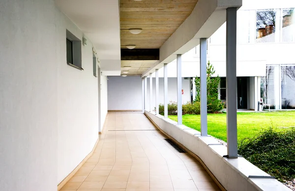 outdoor empty corridor with garden in the modern office building.