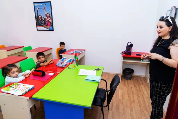 BAKU,AZERBAIJAN-APRIL 17, 2019: children play with toys and engage with the tutor in a kindergarten, school.