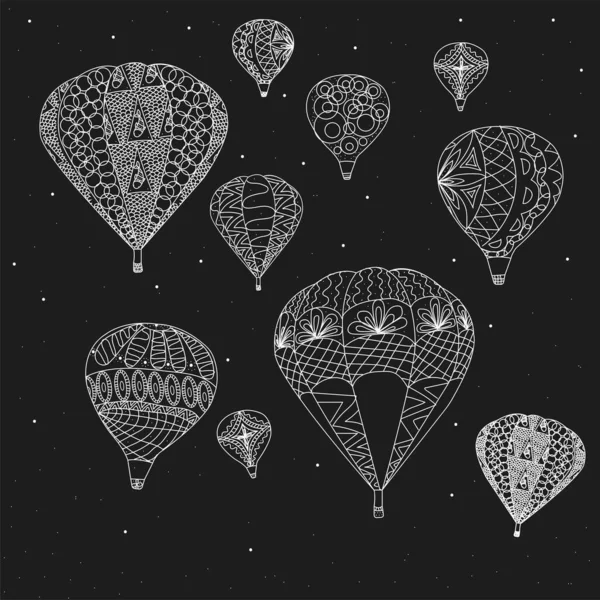 Siyah arka planda beyaz boyayla yapılmış balonlar. Kalıplı balonlar