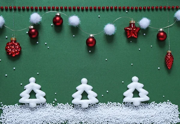 Yeşil arka planda Noel oyuncakları. Tatil tebrik kartı tasarımı.