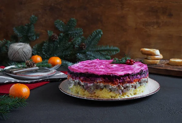 Traditional Russian multilayered salad from herring, beets, potatoes, carrots and eggs. place for text.