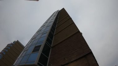 Camdan ve tuğladan yapılmış yüksek katlı bir binanın cephesi