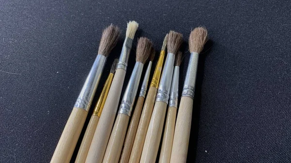 Wooden Brushes Painting Animal Fur Lie Black Table Watercolor Paints — Foto Stock