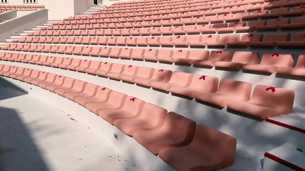 Outdoor theater. Rows of seats on a sunny day with seat tags for coronavirus precautions
