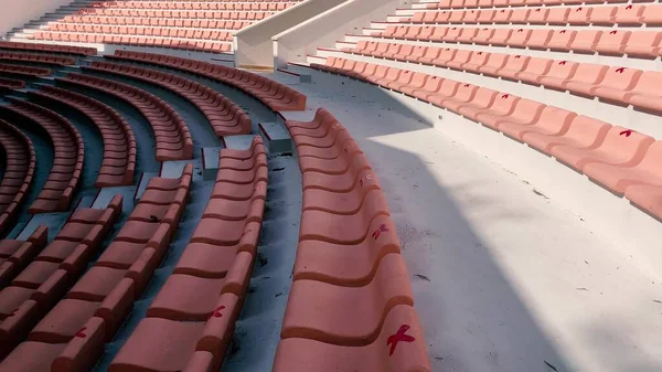 Outdoor theater. Rows of seats on a sunny day with seat tags for coronavirus precautions