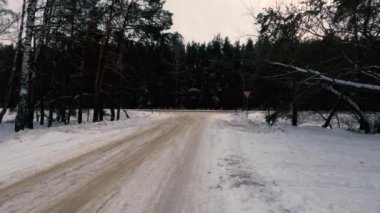 Winter road, tire tread marks and a lot of snow on the road