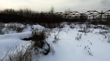 Abandoned Russian industrial area. Old factory, bare concrete in winter, non-working mechanisms, abandoned factory
