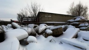 Abandoned Russian industrial area. Old factory, bare concrete in winter, non-working mechanisms, abandoned factory