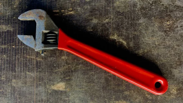 Old Adjustable Wrench Red Handle Lies Workshop Table — Stock Photo, Image