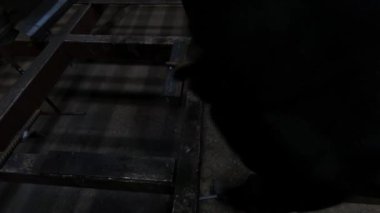 Metal atölyesi ustabaşı kaynak makinesi ve çelik bölmelerle çalışır.