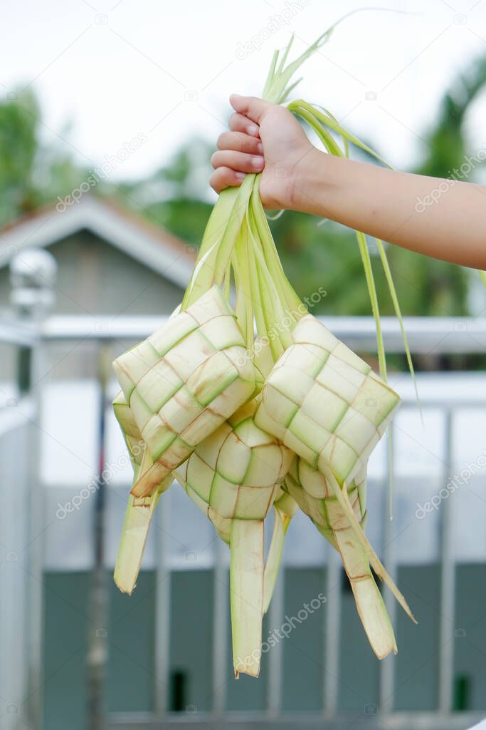 Natural rice ketupat from young coconut leaves with blurred background. (Ketupat) regional specialties in Indonesia