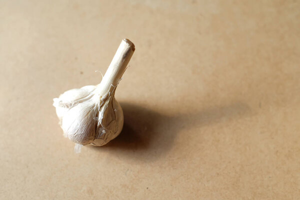 Fresh garlic ready to peel on a wooden table