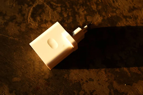 Mobile phone charger adapter on the floor