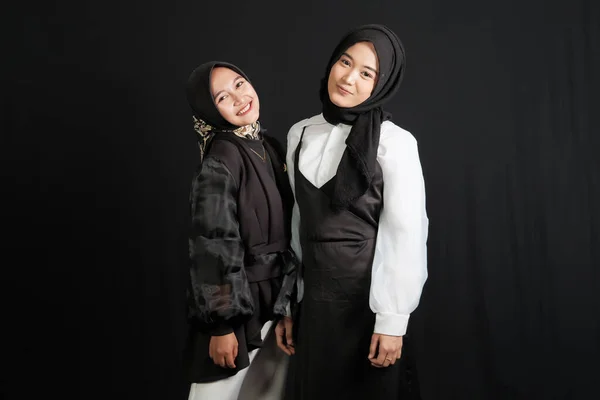 Two Happy Young Asian Muslim Women Interact Isolated Black Background — Stockfoto