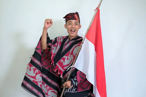 Man Wearing Traditional Woven Clothes Holding Indonesian National Flag Independence — стокове фото