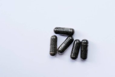 Black cumin capsules or commonly called (Habbatussauda) are isolated on a black background. One of the plants that are often processed into herbal medicine is Black Seed
