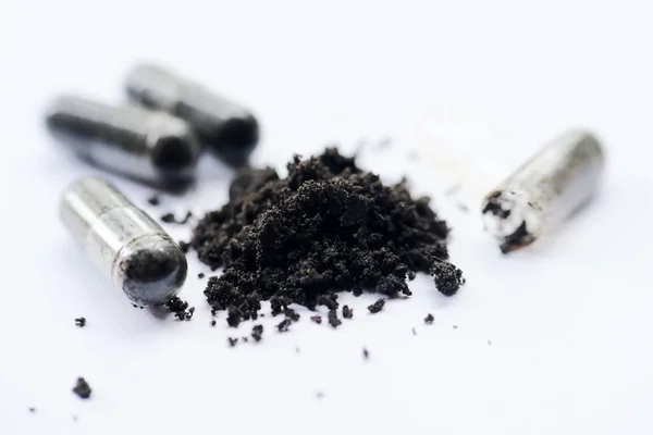 Black cumin capsules or commonly called (Habbatussauda) are isolated on a black background. One of the plants that are often processed into herbal medicine is Black Seed