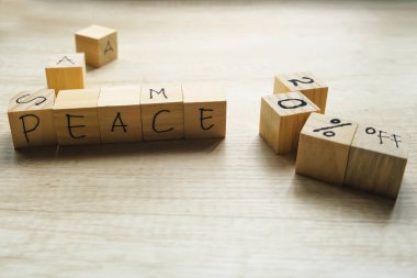 Wooden cube with text, The word is written on wooden cube standing on textured surface.