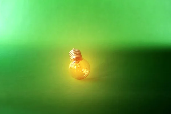 Glowing light bulb and innovation thinking creative concept on dark green background, success inspiration with energy saving