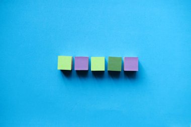 Colorful wooden blocks isolated on a light blue background