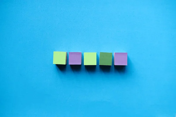 Colorful wooden blocks isolated on a light blue background