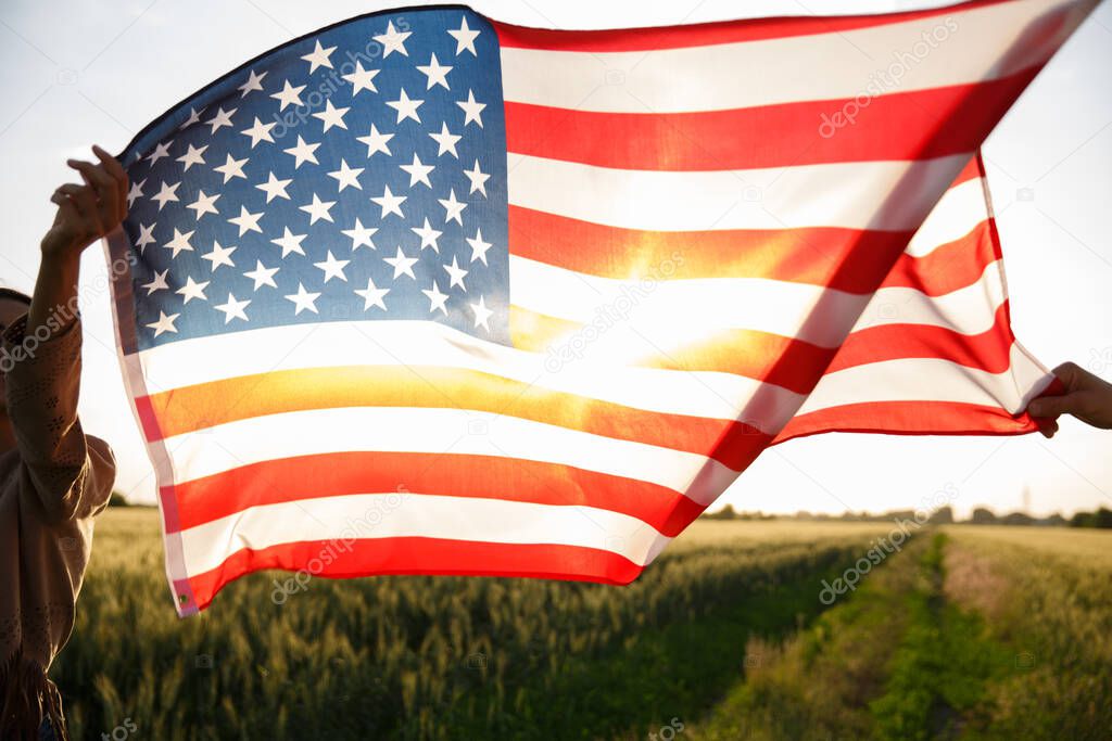 4th of July. Fourth of July. USA flag against beautiful landmark on sunset. Independence Day celebrating, American national patriotic holiday, democracy and veteran respect concept