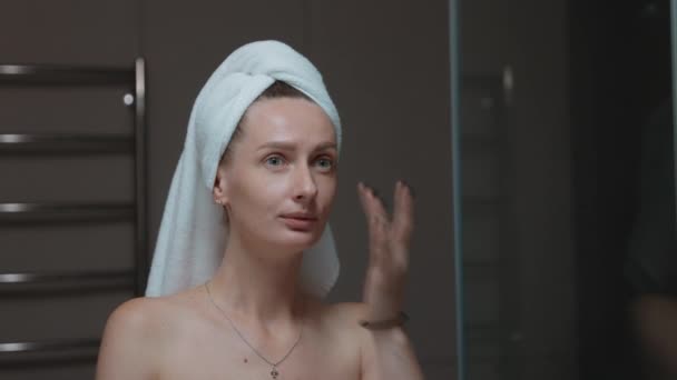 Woman Towel Wrapped Her Head Massaging Her Face Bath Mirror — Stock Video