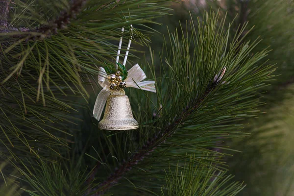 Toy bell on a Christmas tree on the street — Stock Photo, Image