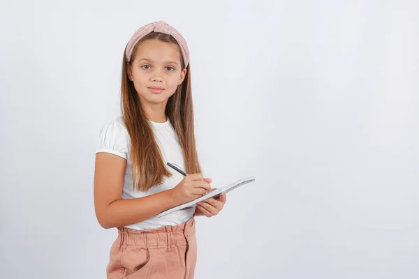 Girl Looking Camera Writing Notebook High Quality Photo — Stockfoto