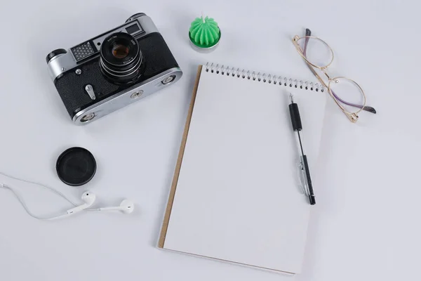 vintage camera and notebook lie on the table. High quality photo