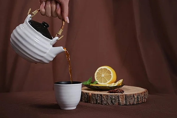 Female Hand Pours Tea Cup Next Lemon Mint — Stockfoto