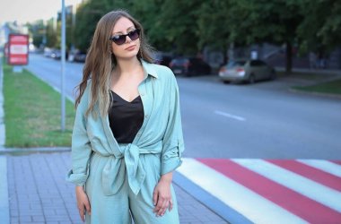 girl is waiting to cross the pedestrian crossing. High quality photo