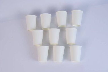  many white glasses lie on a cardboard table. High quality photo