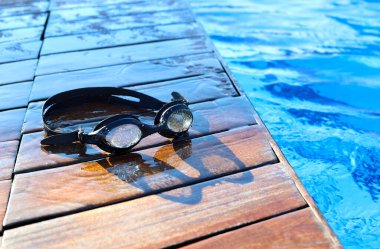 swimming goggles near the pool. High quality photo
